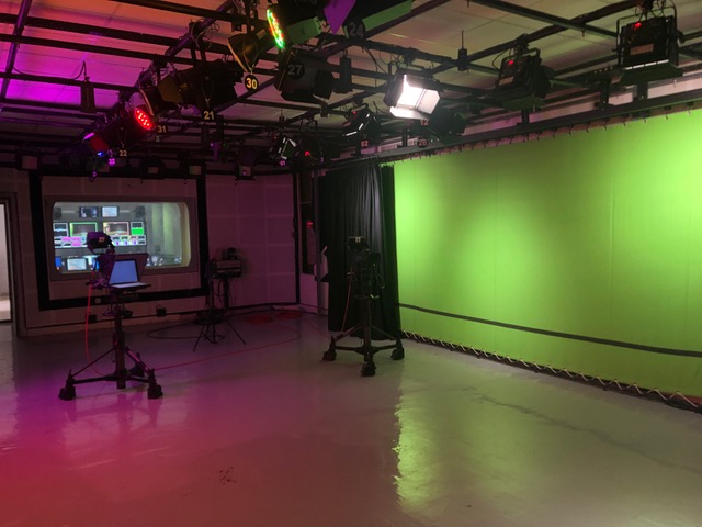 A TV production room with a lot of screen and lights
